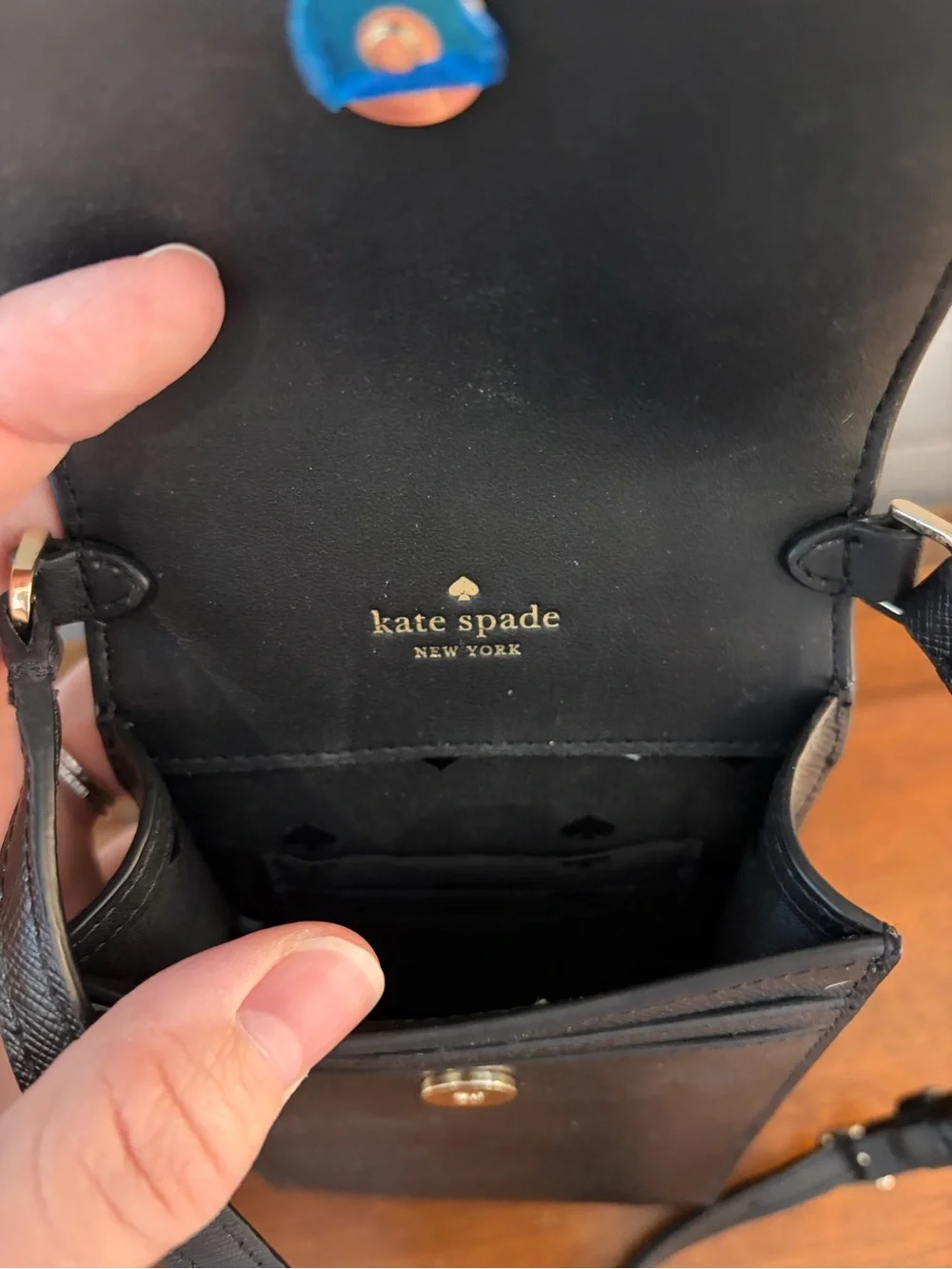 kate spade black saffiano leather phone pouch with gold logo